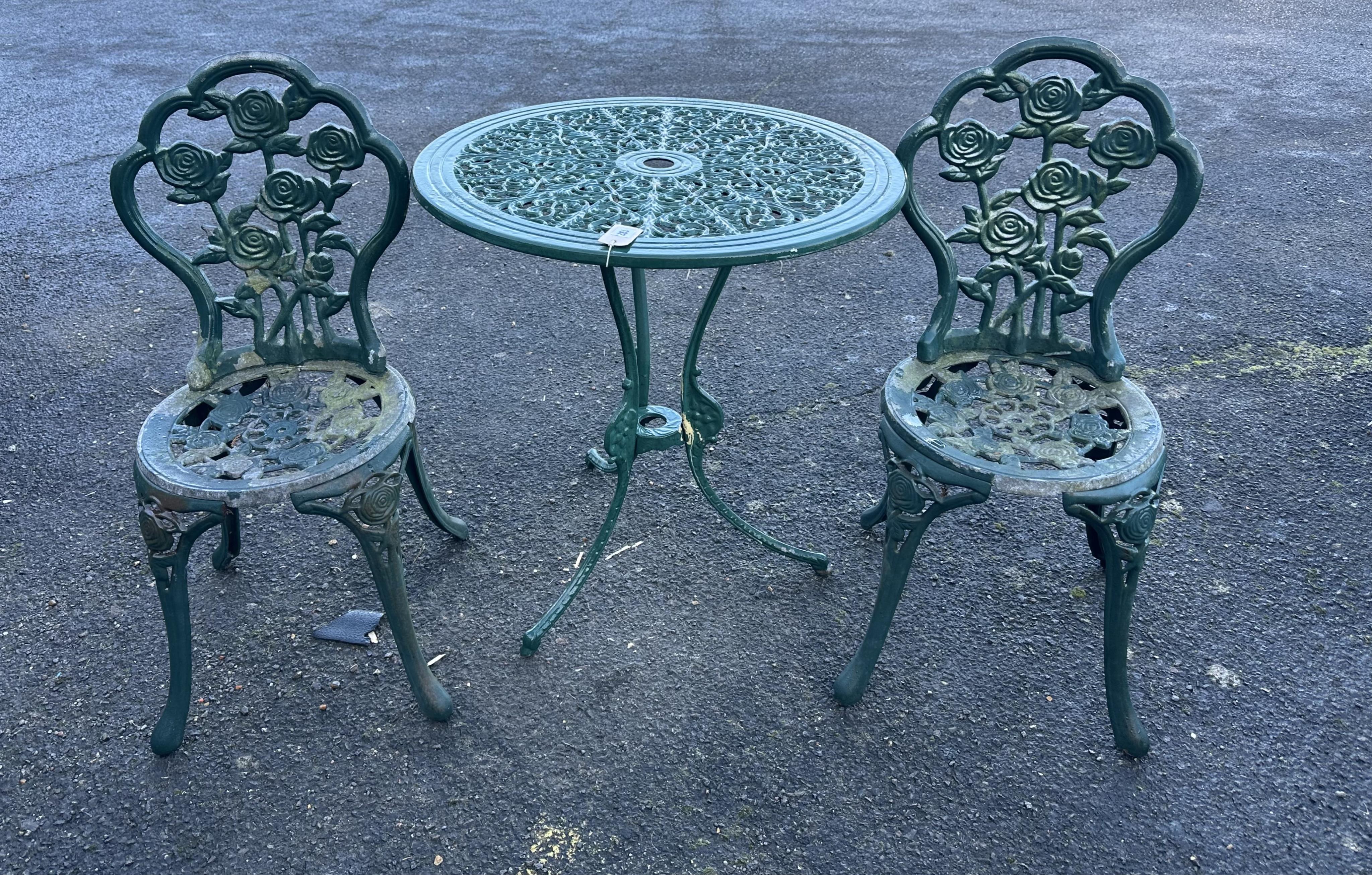 An aluminium garden table, diameter 68cm and a pair of chairs. Condition - poor